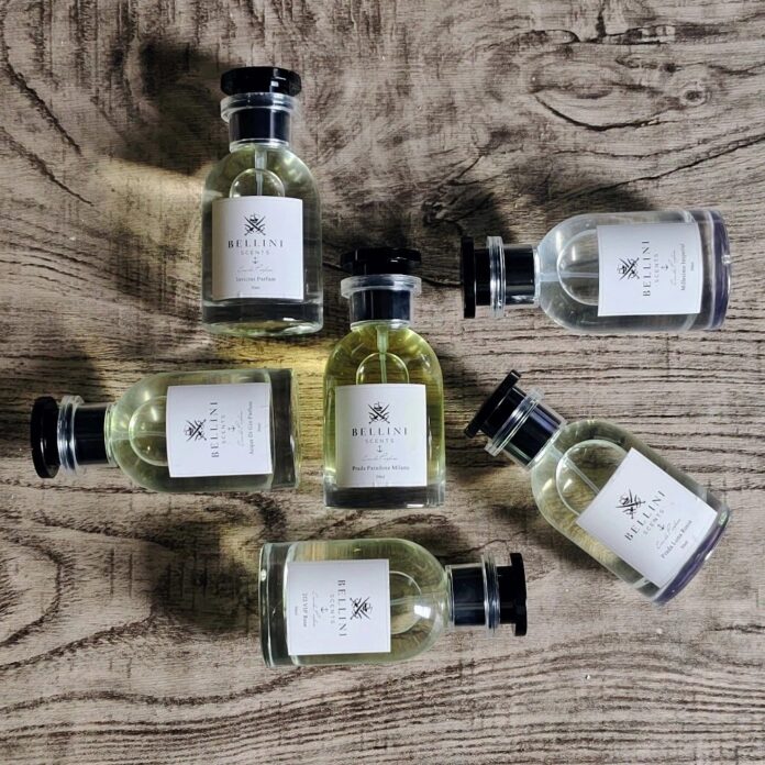 A imagem mostra seis frascos de perfumes Bellini Scents, em um fundo amadeirado